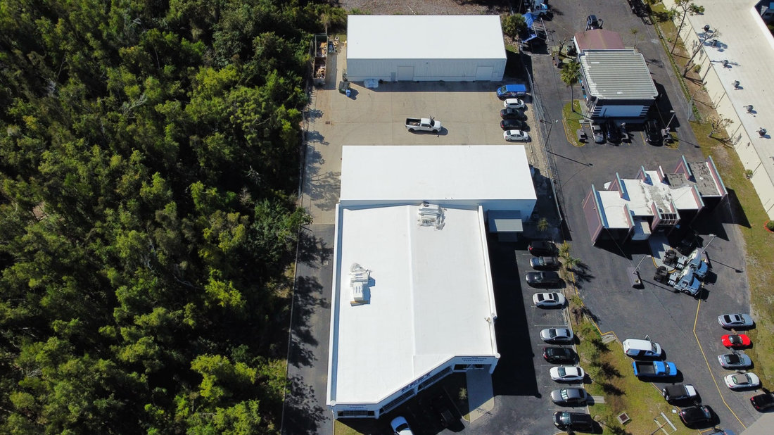 Aerial view of a white low-slope commercial roof