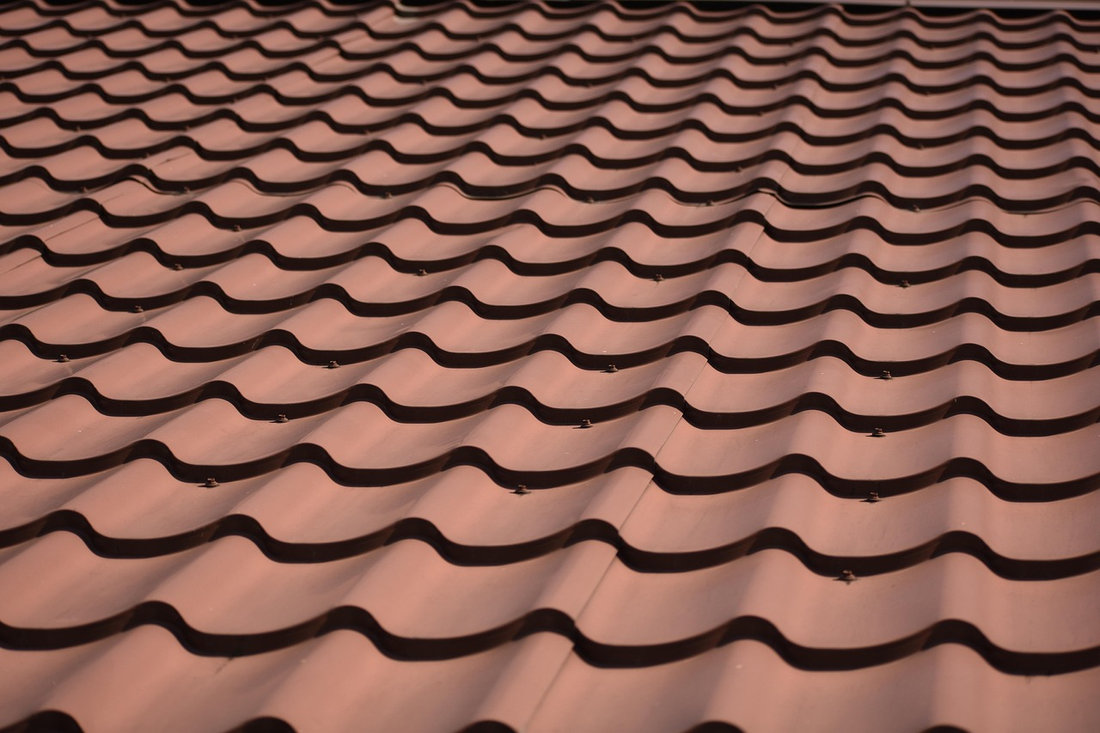 Close view of repeating curved roof tiles
